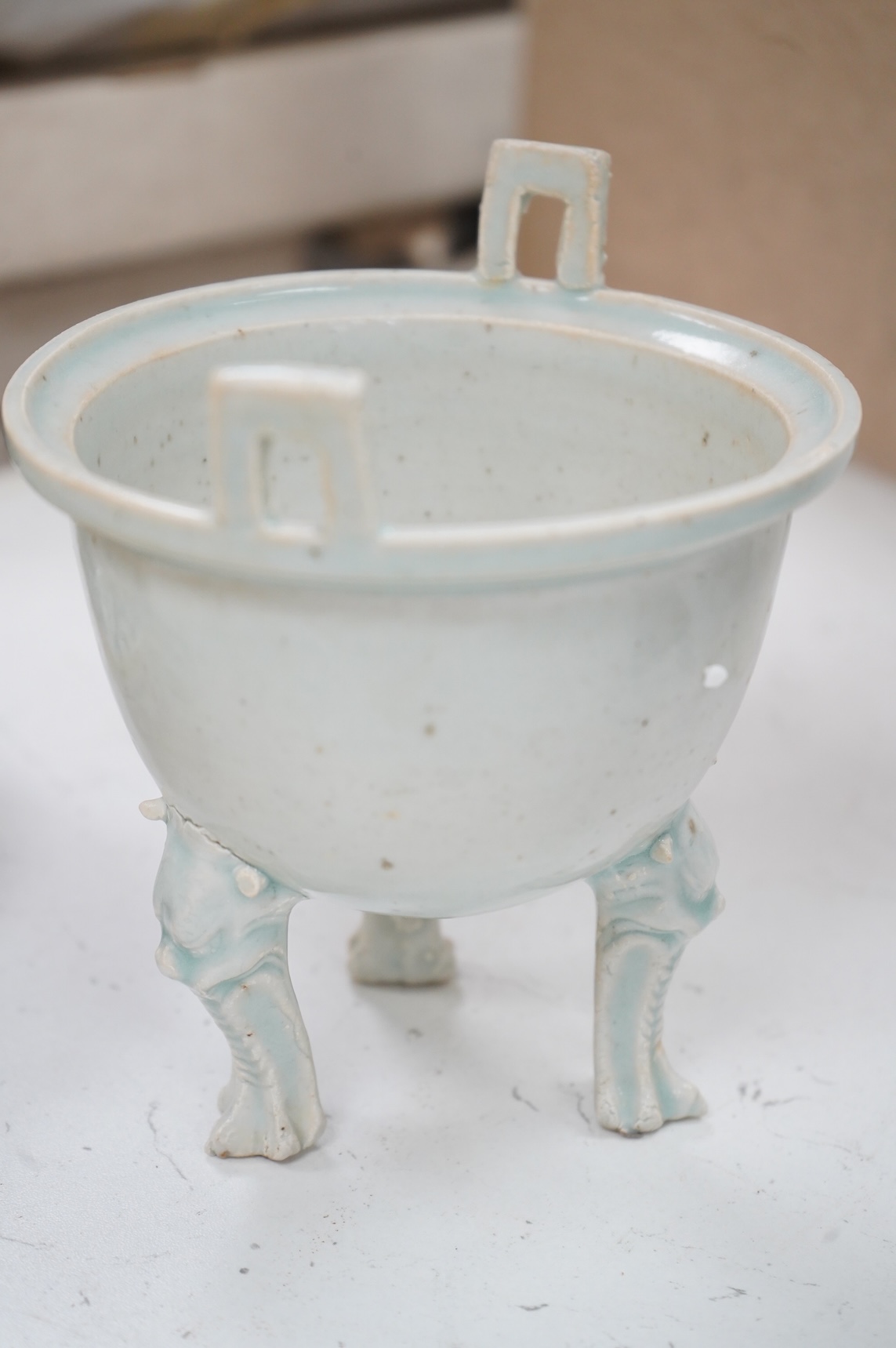 A Chinese three footed censer and a blue and white pouring bowl, largest 15cm high